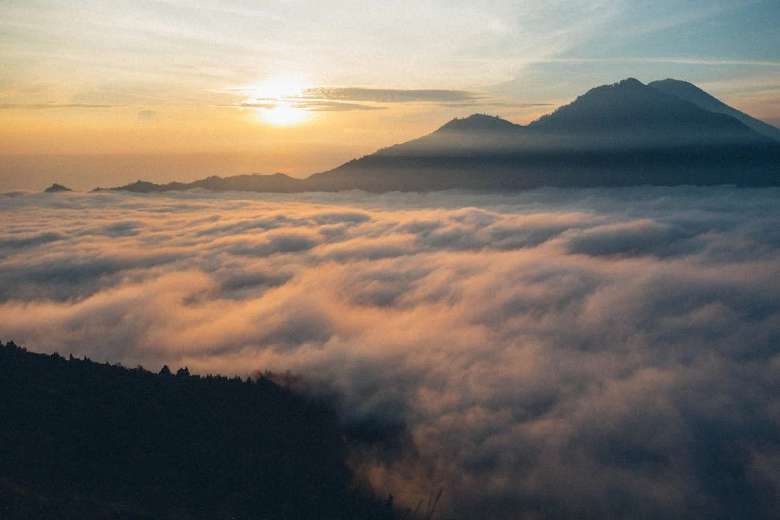 Landscape with mountains and mist at sunset