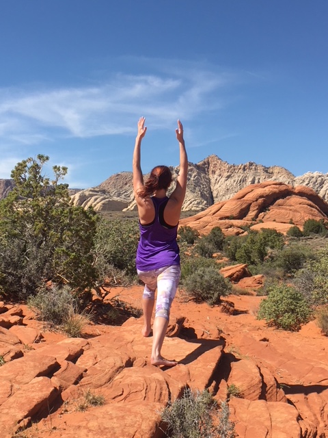 Dr. Deirdre Conroy in the desert, stretching her arms above her head.